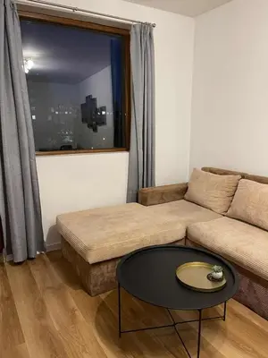 a living room with a couch and a table at Heart of Plovdiv - 2 bedrooms, Private garage in Plovdiv