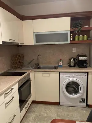 a kitchen with a washing machine and a sink at Heart of Plovdiv - 2 bedrooms, Private garage in Plovdiv