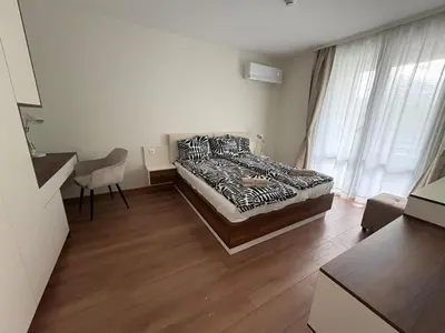 a bedroom with a bed and a desk and window at New Urban Stay Airport city center metro access in Sofia