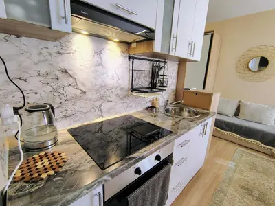 a kitchen with a marble counter top and a sink at Charming Studio 88 in Bansko