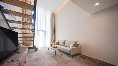 a living room with a couch and a tv at Hotel Complex SamElyon in Samokov