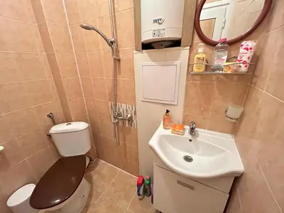 a small bathroom with a toilet and a sink at Sunlight Suite - free private parking - central in Plovdiv