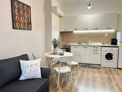 a living room and kitchen with a couch and a table at Sunlight Suite - free private parking - central in Plovdiv