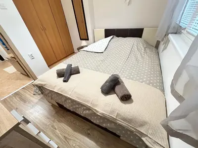 two towels on a bed in a room at Sunlight Suite - free private parking - central in Plovdiv