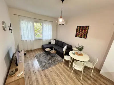 a living room with a couch and a table at Sunlight Suite - free private parking - central in Plovdiv