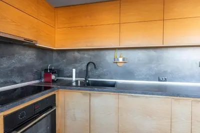 a kitchen with wooden cabinets and a sink at Luna Penthouse Stunning Sofia Skyline plus FREE Parking in Sofia