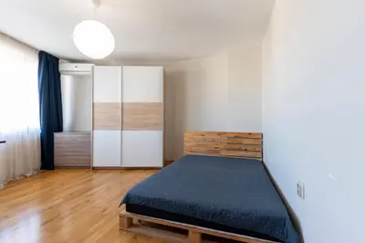 a small bedroom with a bed and a closet at Luna Penthouse Stunning Sofia Skyline plus FREE Parking in Sofia