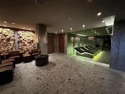 a living room with a bunch of furniture and logs at St Ivan Rilski Spa & Pool Getaway in Bansko