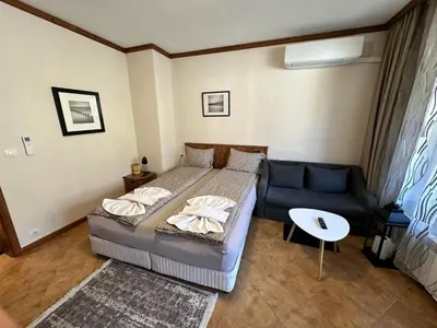 a bedroom with a bed and a couch at St Ivan Rilski Spa & Pool Getaway in Bansko