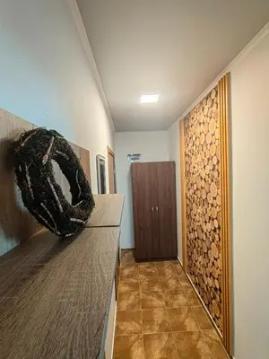 a hallway with a room with a wooden wall at Sunny Mountain View Villa Kometa in Pamporovo