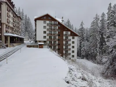 a building in the snow with a lot of snow at Sunny Mountain View Villa Kometa in Pamporovo