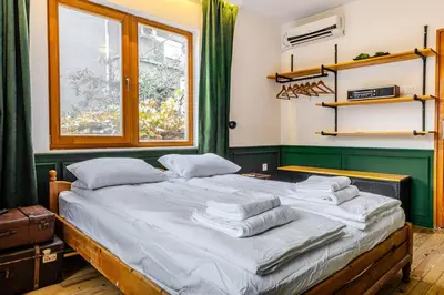 a bedroom with a bed with towels on it at Paganini House close to Center and Rowing Canal in Plovdiv