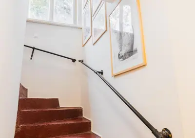 a set of stairs with pictures on the wall at Paganini House close to Center and Rowing Canal in Plovdiv