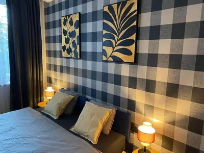a bedroom with a bed with two pillows and two lamps at Apartment City by Wohnsol-mit Terrasse im Centrum in Sofia