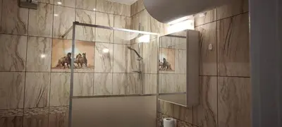 a bathroom with a shower with paintings on the wall at Two-Bedroom Apartment Lauta Park 6 Plovdiv in Plovdiv