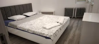 a bed with two pillows on it in a bedroom at Two-Bedroom Apartment Lauta Park 6 Plovdiv in Plovdiv