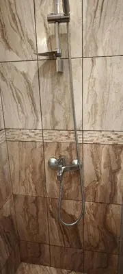 a shower with a hose in a bathroom at Two-Bedroom Apartment Lauta Park 6 Plovdiv in Plovdiv