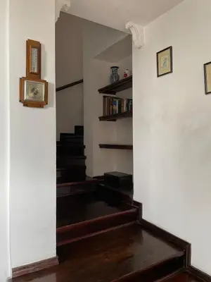 a hallway with a stairway with a stair case at Райска тишина in Zlatitsa