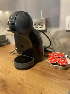 a coffee maker sitting on a table next to cupcakes at Two Modern Apartments in One Building by SI Stay in Bansko