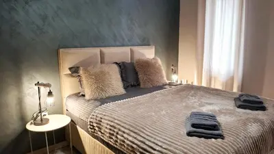 a bedroom with a bed with pillows on it at Two Modern Apartments in One Building by SI Stay in Bansko