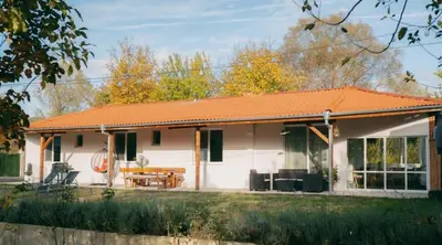 a small white house with an orange roof at Guest house by the river in Simitli