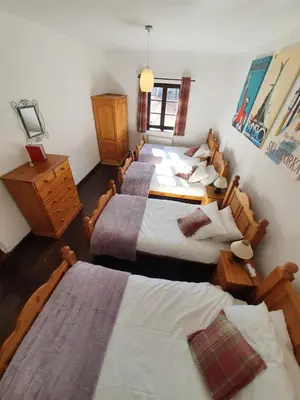 a group of four beds in a room at Chalet Jora - Total Chalets in Bansko
