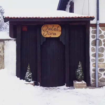a garage with a sign on it in the snow at Chalet Jora - Total Chalets in Bansko