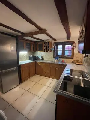a kitchen with wooden cabinets and a stainless steel refrigerator at Chalet Jora - Total Chalets in Bansko