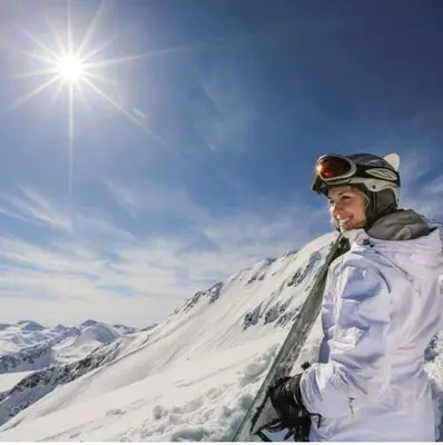 a man standing on top of a snow covered mountain at Chalet Jora - Total Chalets in Bansko