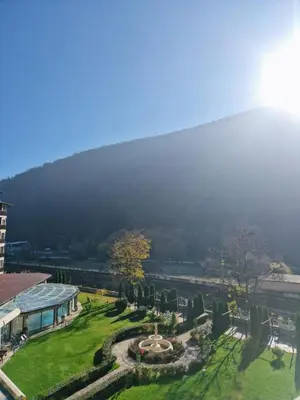 a view of a park with a building and a fountain at Apartment VIP in Hotel Sveti Spas in Velingrad