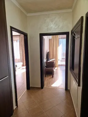 a hallway with two doors and a desk in a room at Apartment VIP in Hotel Sveti Spas in Velingrad