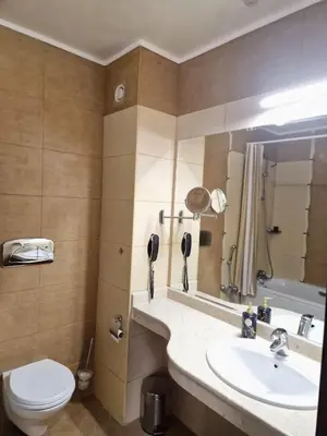 a bathroom with a sink and a toilet at Apartment VIP in Hotel Sveti Spas in Velingrad