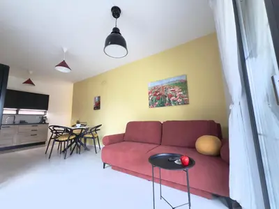 a living room with a red couch and a table at Sofia 3-Bedroom Mountain Family Apartment with Free Parking in Sofia