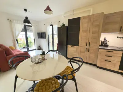 a kitchen with a table and chairs in a room at Sofia 3-Bedroom Mountain Family Apartment with Free Parking in Sofia