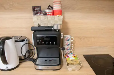 a coffee maker sitting on top of a table at Apartment Bee Happy, Pchelinski Bani,Hot mineral water in Pchelin
