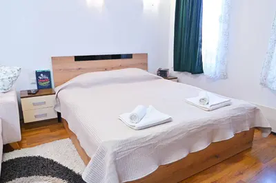 a bedroom with a white bed with two towels on it at Apartment Breath - Peaceful Stay Near Gondola Lift by Flat Mаnаger in Bansko