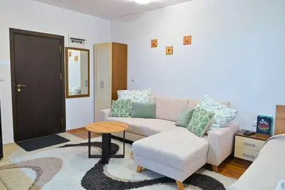 a living room with a couch and a table at Apartment Breath - Peaceful Stay Near Gondola Lift by Flat Mаnаger in Bansko