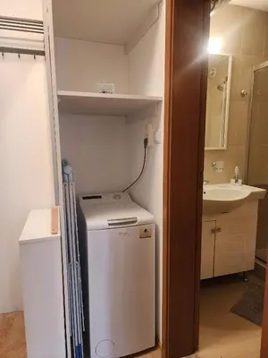 a small kitchen with a refrigerator and a sink at Apartment Viktoria near ski lift on Pirin street in Bansko