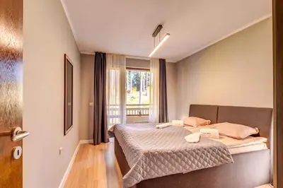 a small bedroom with a bed and a window at Alpine Escape at Dream View in Pamporovo
