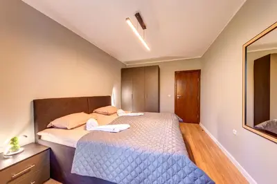 a small bedroom with a bed and a mirror at Alpine Escape at Dream View in Pamporovo