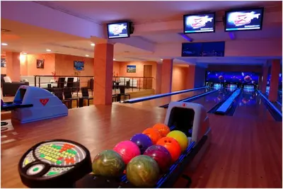 a bowling alley with pins and balls in a lane at Grand Monastery 3 Apartment 10 in Pamporovo