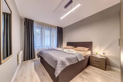 a small bedroom with a bed and a window at Ski Slope Retreat at Dream View in Pamporovo