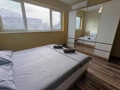 a bedroom with a large bed and a mirror at 20th Residence Studio 11 in Sofia