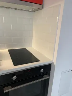a small kitchen with a stove top oven at Stylish 1BR near Centre in Sofia