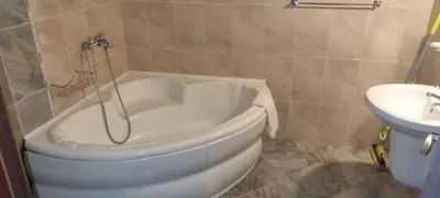 a white tub in a bathroom with a sink at Elit Pamporovo Apartments in Pamporovo