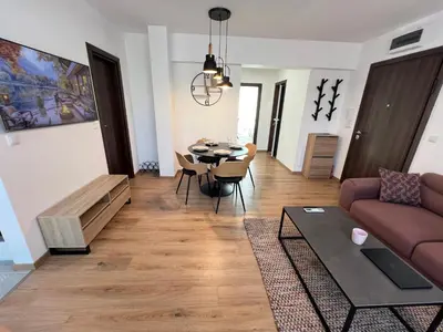 a living room with a couch and a table at Marrakech Central 2BDR w Huge Terrace near Serdika in Sofia