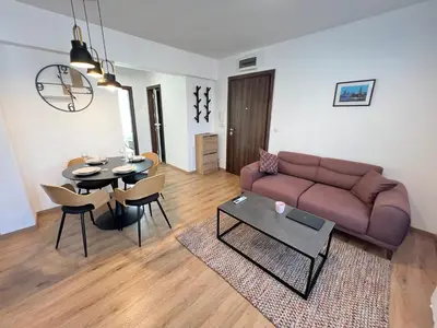 a living room with a couch and a table at Marrakech Central 2BDR w Huge Terrace near Serdika in Sofia
