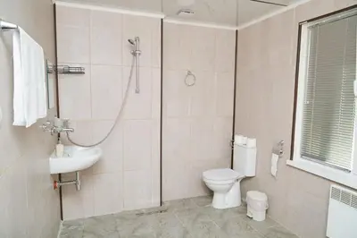 a bathroom with a shower and a toilet and a sink at Вила Владислава - стаи за гости in Cherni Vit