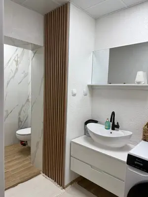 a white bathroom with a sink and a toilet at Atelier-apartament in Sandanski