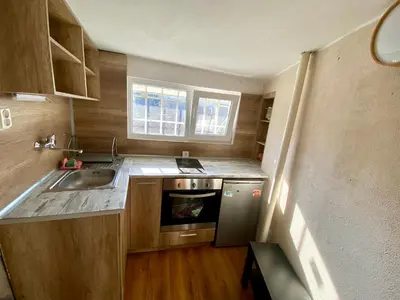 a small kitchen with a sink and a stove at Small Bijou on the rooftop in Sofia